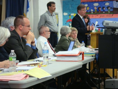 Town counsel is informing the audience about a legal issue in connection with eminent domain